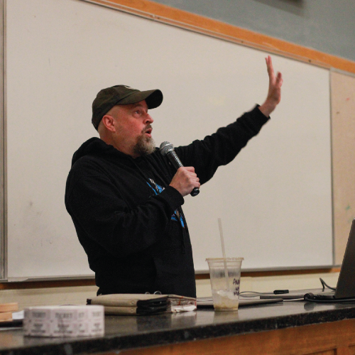 Man with baseball cap and microphone