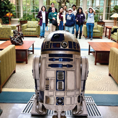 MDes students visiting ILM (Industrial Light and Magic, where franchises like Star Wars are developed) Students posing with R2-D2