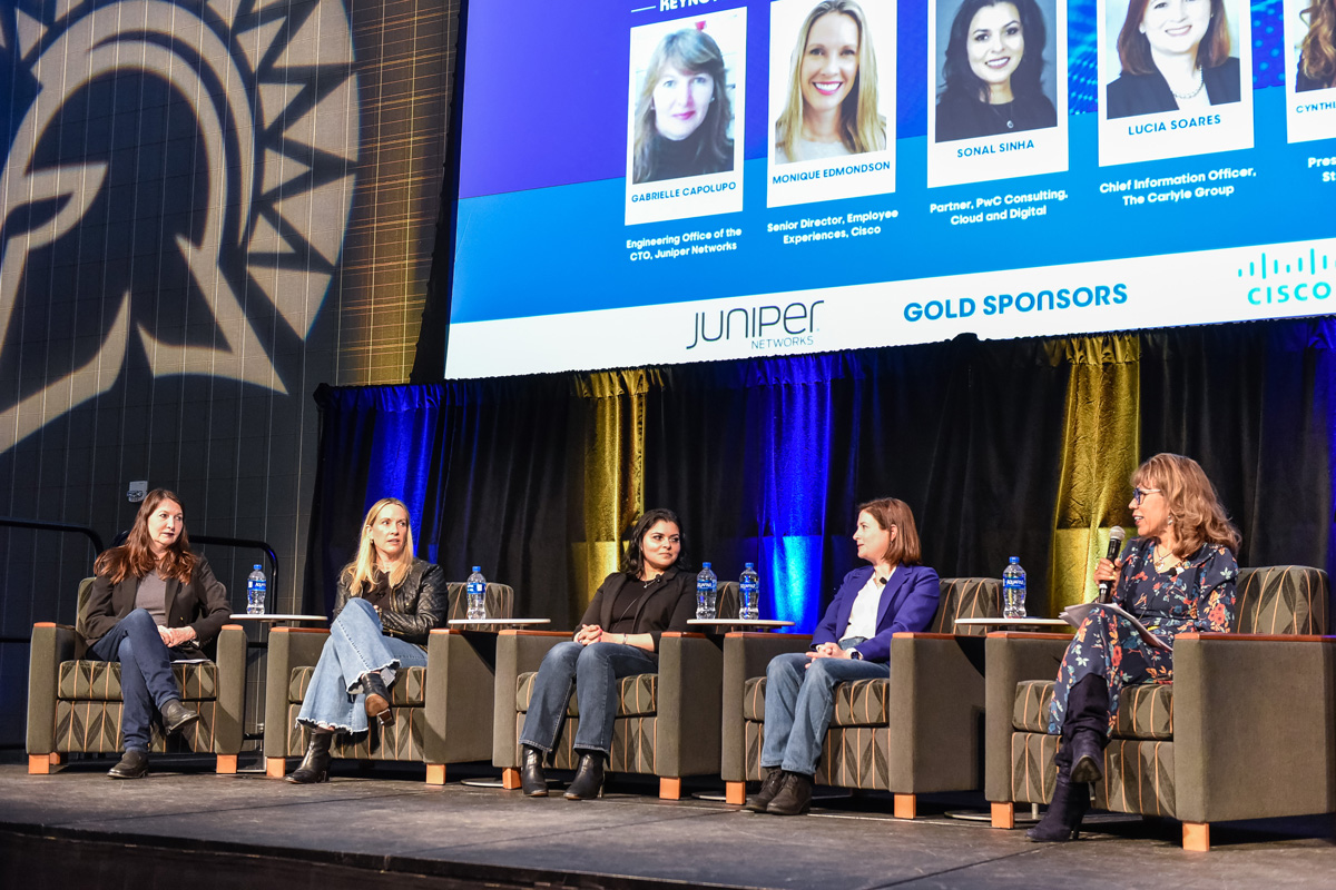 The president speaking with the panel on stage.