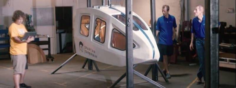 Students and faculty work on podcar prototype.